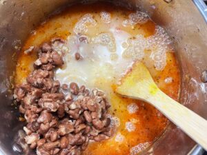 Broth added to a soup pot.