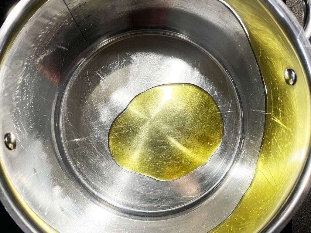 Oil heating in a pot.