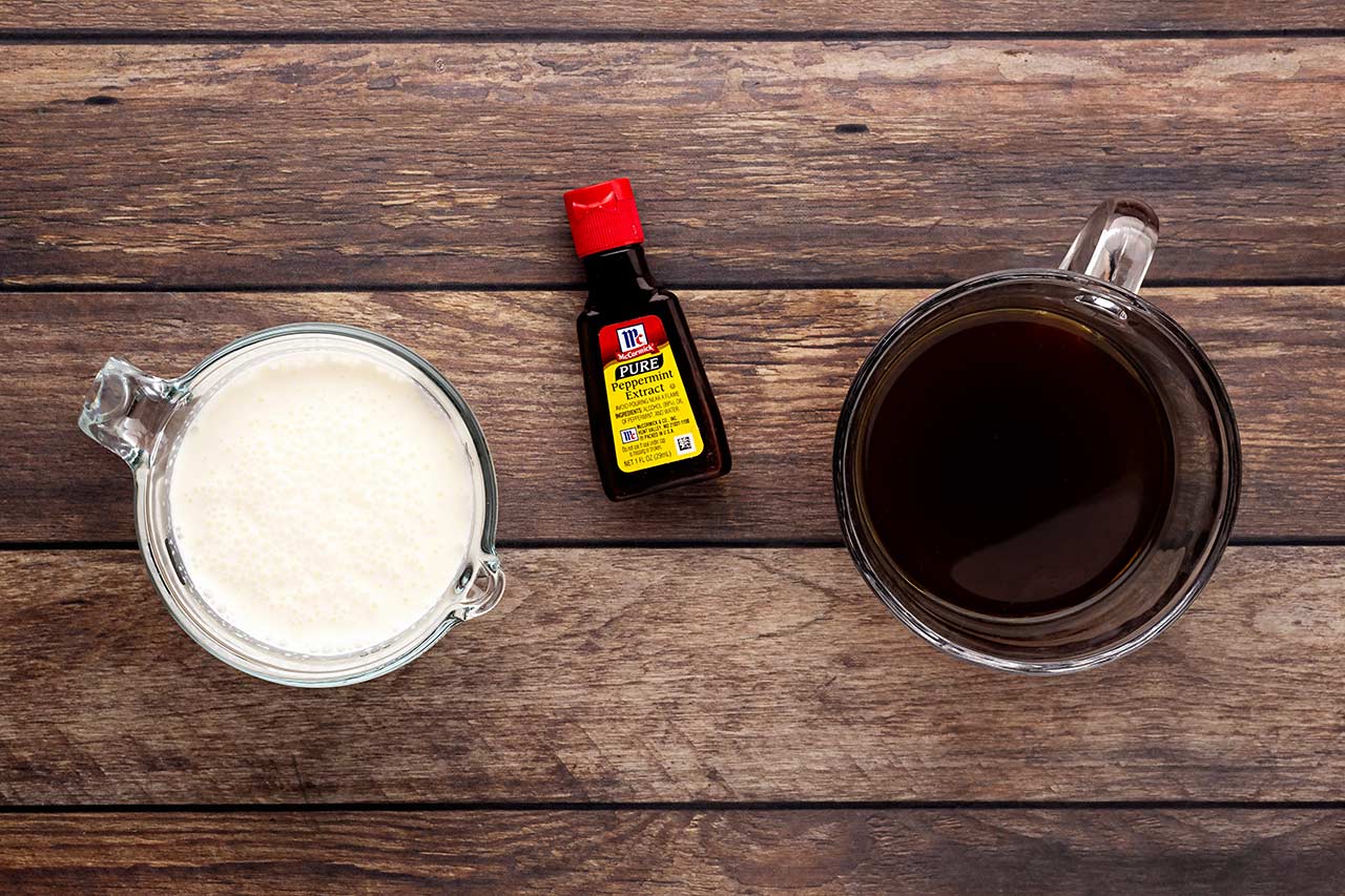 Peppermint Latte Recipe ingredients on a wood surface.