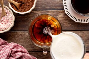 Adding milk to peppermint coffee.