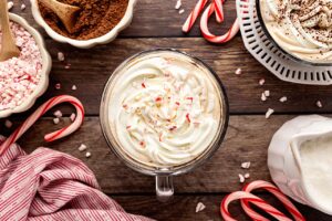 Whipped cream and crushed candy canes topping a Peppermint Latte. Overhead focus.