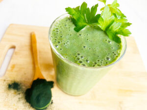 Partial overhead focus. A glass full of Spirulina Smoothie.