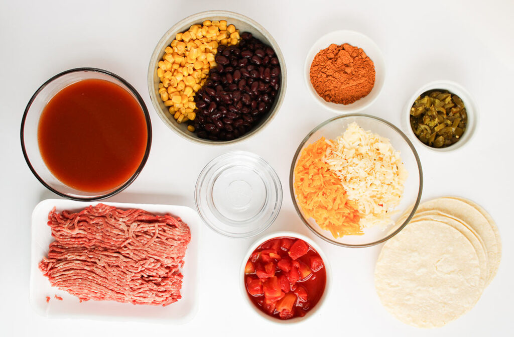 Beef Enchilada Casserole recipe ingredients on a white surface.