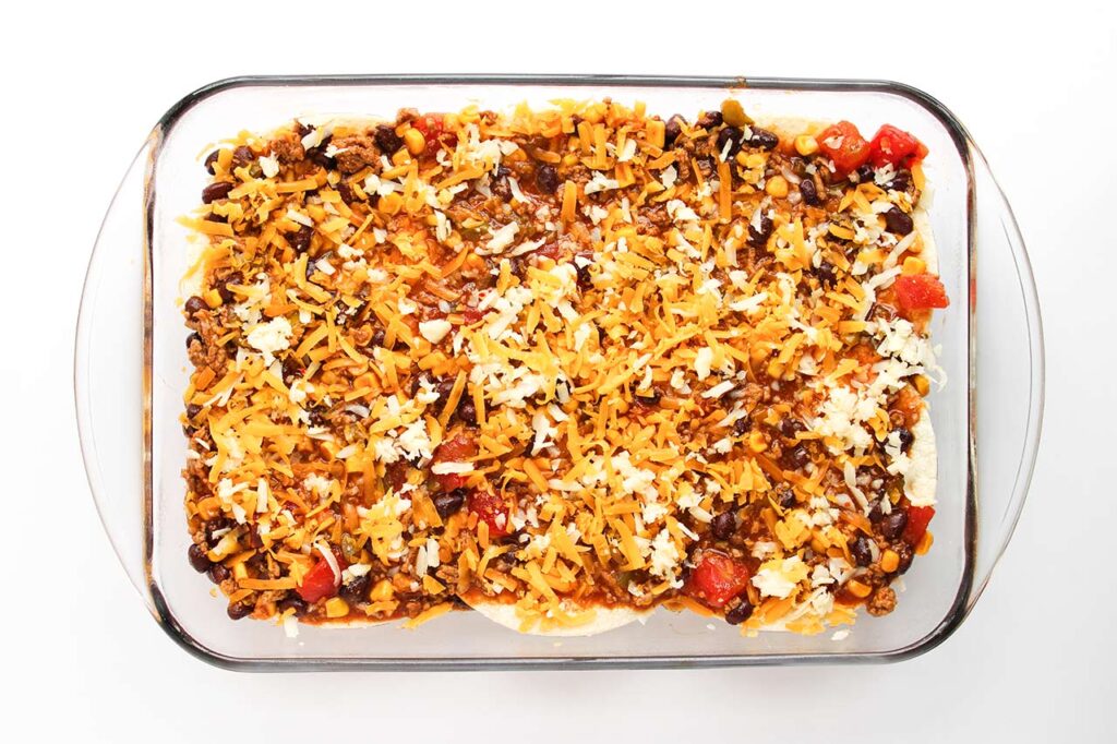 Beef Enchilada Casserole topped with shredded cheese..