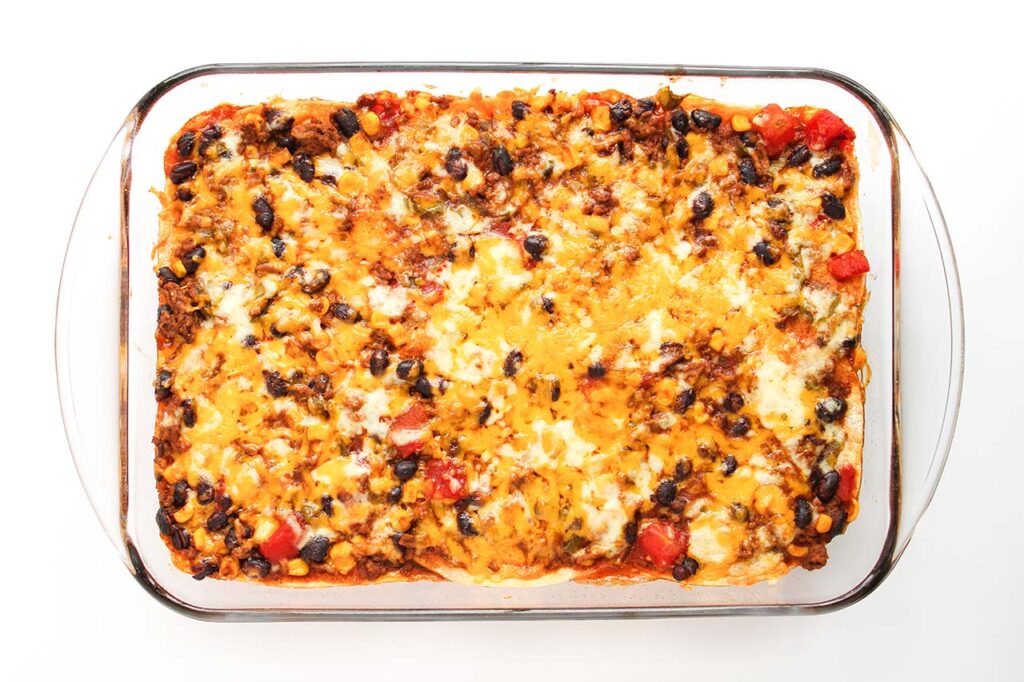 Beef Enchilada Casserole with cheese melted over the top.