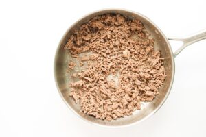 Ground beef cooked and sitting in a skillet.