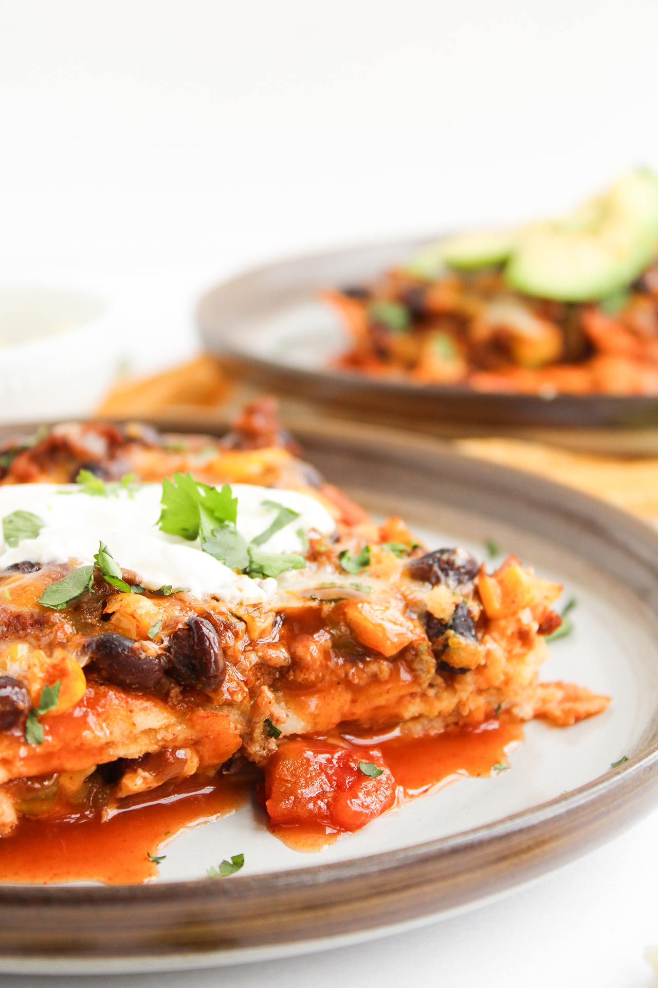 Front, closeup focus. A plate with Beef Enchilada Casserole.